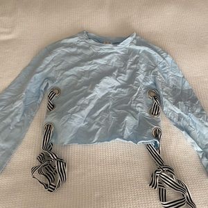Light blue top with ties on the sleeve